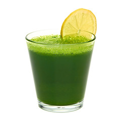 Wheat grass juice with lemon slice in glass on white background