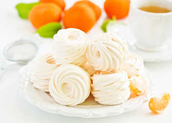 Delicious homemade marshmallows and oranges with spices.