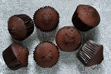 Chocolate muffins on a gray concrete background. Cupcakes. Cake.
