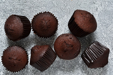 Chocolate muffins on a gray concrete background. Cupcakes. Cake.