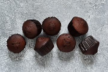 Chocolate muffins on a gray concrete background. Cupcakes. Cake.