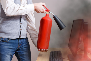Man using fire extinguisher to stop fire in business center. Concept of protection and security 