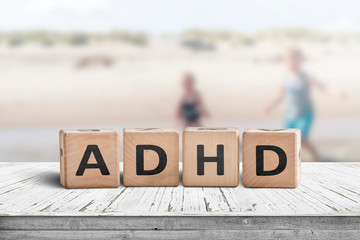 ADHD sign on a wooden table with kids
