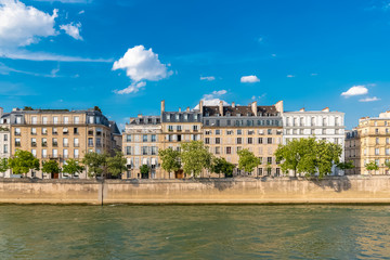Fototapeta na wymiar Paris, view of ile saint-louis and quai d'Orleans, beautiful buildings and quays in summer 