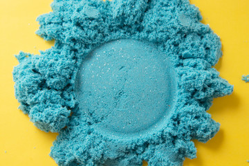 Bluekinetic sand texture with copy space. Creativity, education and play games for children. Close up.