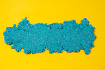 Bluekinetic sand texture with copy space. Creativity, education and play games for children. Close up.