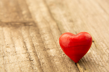 Fototapeta premium Two red hearts on wooden background, close-up, Valentine's day, celebrating love.