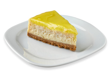 Slice of cheese cake with lemon in porcelain dish or plate isolated on white background.