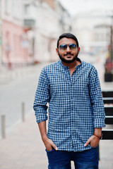 Stylish indian beard model man in casual clothes posed outdoor at street of India.