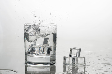 water with ice in a glass with splashes