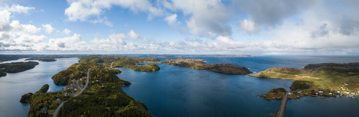 Aerial view of a small town on a rocky Atlantic Ocean Coast during a cloudy day. Taken in Herring Neck, Newfoundland, Canada.