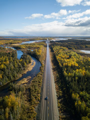 Aerial view of a scenic road during a beautiful sunny day in the Autumn. Taken near Grand Falls-Windsor, Newfoundland, Canada.