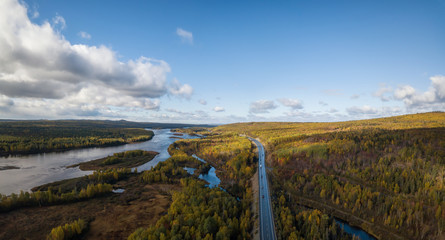 Aerial panoramic view of a scenic road during a beautiful sunny day in the Autumn. Taken near Grand Falls-Windsor, Newfoundland, Canada.