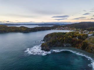 Fototapeta na wymiar Aerial Canadian Landscape View by the Atlantic Ocean Coast during a cloudy sunrise. Taken in Beachside, Newfoundland, Canada.
