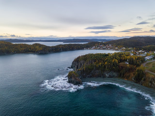 Aerial Canadian Landscape View by the Atlantic Ocean Coast during a cloudy sunrise. Taken in Beachside, Newfoundland, Canada.