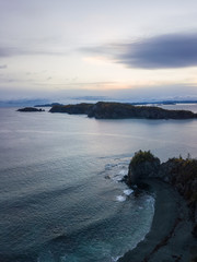 Aerial Canadian Landscape View by the Atlantic Ocean Coast during a cloudy sunrise. Taken in Beachside, Newfoundland, Canada.