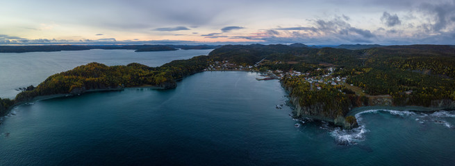 Aerial panoramic Canadian Landscape View by the Atlantic Ocean Coast during a cloudy sunrise. Taken in Beachside, Newfoundland, Canada.