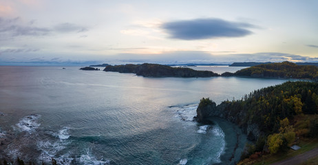 Aerial panoramic Canadian Landscape View by the Atlantic Ocean Coast during a cloudy sunrise. Taken in Beachside, Newfoundland, Canada.