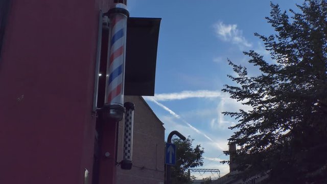 A spinning barber pole on a building.