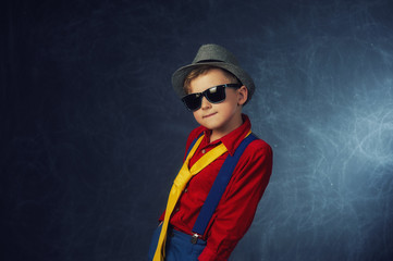 Stylish fashion portrait of boy in Studio on dark background