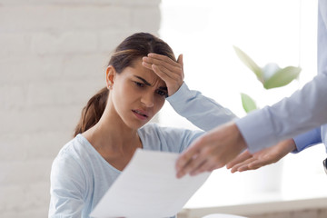 Upset surprised woman receiving bad news, dismissal notice, document, letter with unexpected information from boss, female intern getting fired from work, notification about debt, mistake in job