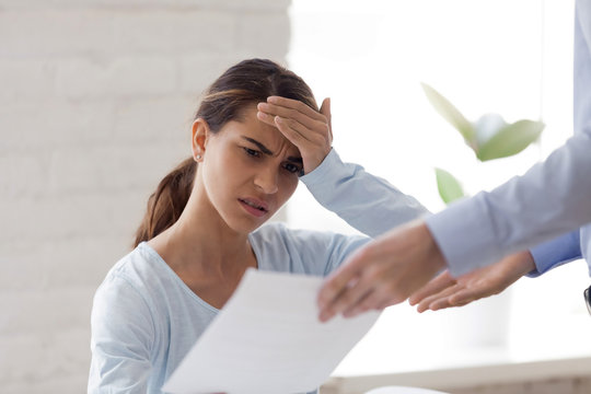 Upset surprised woman receiving bad news, dismissal notice, document, letter with unexpected information from boss, female intern getting fired from work, notification about debt, mistake in job