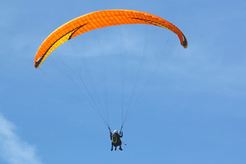 Tandem paraglider flying