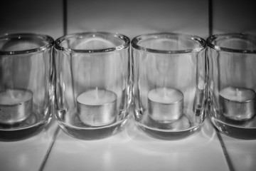 Accessories candlesticks on glass background. Tint composition for home, beauty salon and spa salon. Artistic retouching.