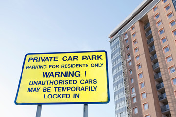 Private parking residents only sign and flats tower block