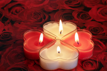 Heart shaped candle burning red and White