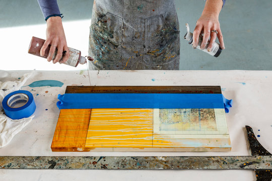 Midsection of female artist working in studio