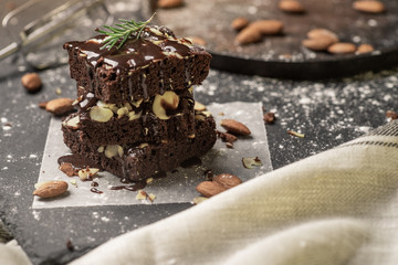 A stack of chocolate brownies on dark plat background ,homemade bakery and dessert.