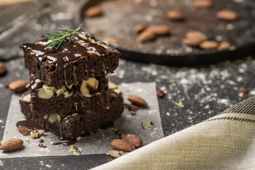 A stack of chocolate brownies on dark plat background ,homemade bakery and dessert.