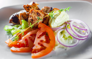 fried chicken breast piece fillet with vegetables salad on white plate