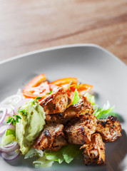 fried chicken breast piece fillet with vegetables salad on white plate