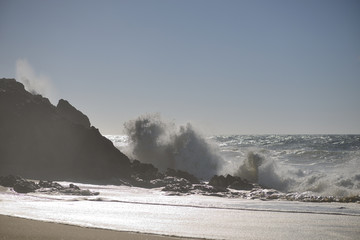 waves crashing on cliffs portugal