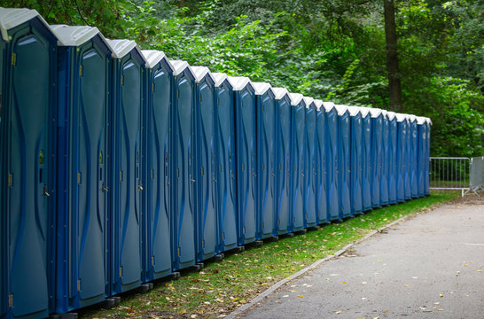 Bio public wc at a park. Locked, portable chemical lavatories. Nature background.