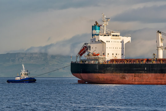 Tugboat pulling a Cargo Ship