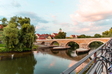 Fototapeta na wymiar Footbridge the Stone Bridge across the Danube river. Popular tourist destinations in Regensburg, Germany. 