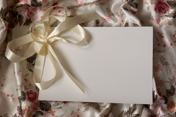 Blank White Card on Floral Silky Background