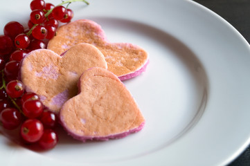 Heart shaped pancakes with currant for Valentine's day