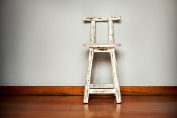 White Wooden Stool Against Wall