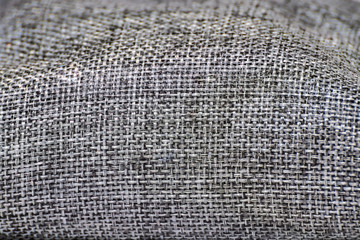 Close up on black, white, gray woven textured canvas fabric/ crocus sack