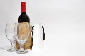 Bottle of Red Wine, two wineglasses and  a white gift bag. Anniversary. Her Birthday. Valentines Day.