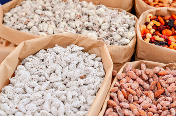 Assorted nuts in paper boxes for sale in the market. Selective focus. Copy space.