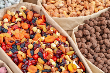 Assorted nuts in paper boxes for sale in the market. Selective focus. Copy space.