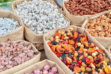 Assorted nuts in paper boxes for sale in the market. Selective focus. Copy space.