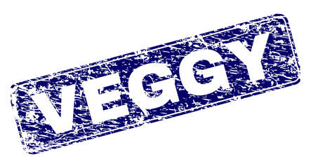 VEGGY stamp seal print with distress texture. Seal shape is a rounded rectangle with frame. Blue vector rubber print of VEGGY text with scratched texture.