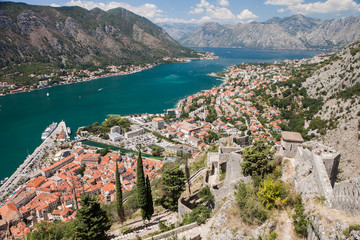 Fototapeta premium Kotor fortress walls and fort stairs view. Kotor Bay, Old Town rooftops. Boka Kotorska, Montenegro