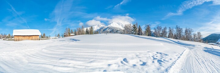 Fototapeta na wymiar Wide panoramic view of winter landscape with snow covered trees and Alps in Seefeld in the Austrian state of Tyrol. Winter in Austria